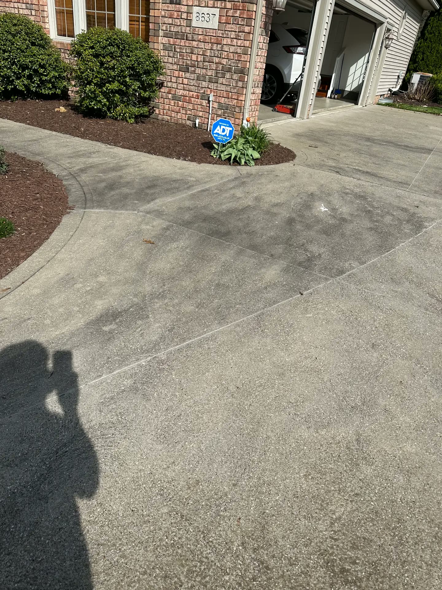 Gray, stained concrete walkway before cleaning