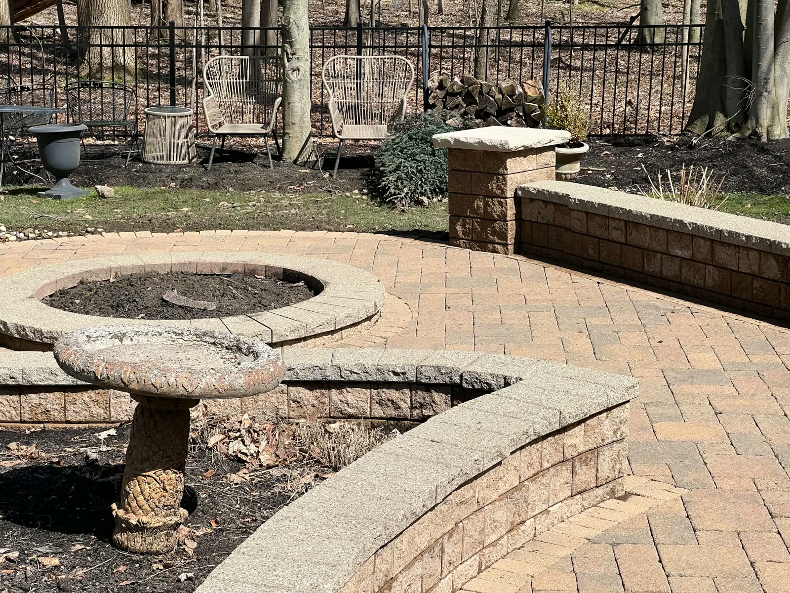 Freshly washed paver patio and seat walls behind a Stark County home